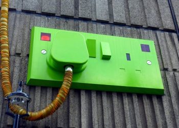 Green Rectangular Corded Machine on Grey Wall during Daytime