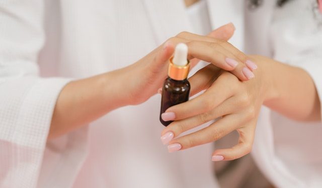 A Person Applying Serum on Hands
