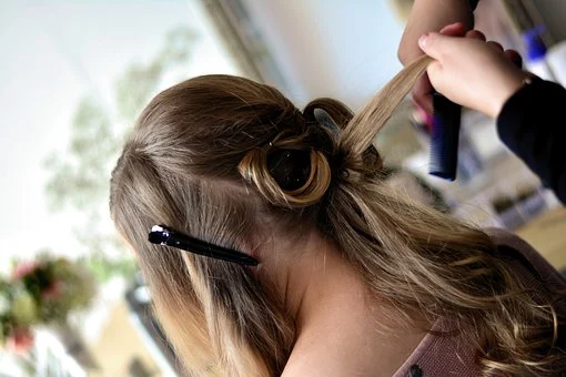 a person making hairstyle