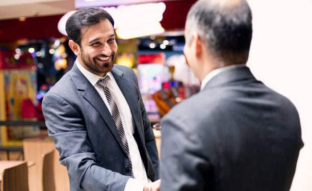 Indian businessmen handshake at coffee shop