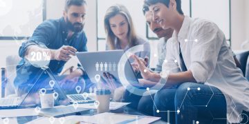 Concept of digital diagram,graph interfaces,virtual screen,connections icon on blurred background.Coworking team at business meeting.Group of colleagues working with startup project in modern office